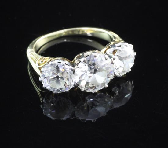 A Victorian style gold three stone diamond ring, size O.